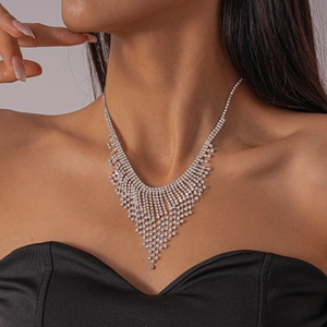 Detail of elegant silver tassel necklace with cascading rhinestones on a model