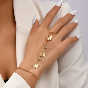 Detail of gold butterfly bracelet ring set with sparkling crystals on model hand