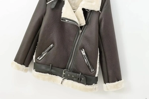 Detail of dark faux leather biker jacket with white sherpa lining and silver zippers