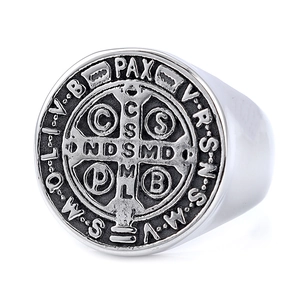 Detailed close-up of vintage Saint Benedict medal seal on an oxidized silver signet ring