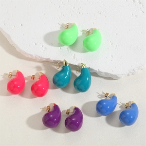 Close-up of colorful enamel teardrop earrings in green, blue, pink, and purple shades