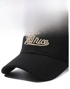 Detail of black baseball cap featuring gold Jeamice embroidery and textured fabric