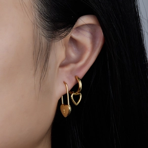 925 silver heart zircon earrings in gold plating shown on a model for a stylish layered look