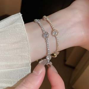 Elegant adjustable flower tennis bracelet with sparkling zircons in silver and gold tones