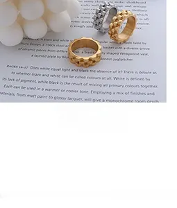 Macro shot of irregular wavy textured rings in gold and silver finish on magazines