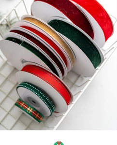 Assorted Christmas ribbons with velvet, satin, and plaid patterns in a white basket