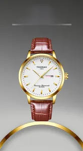 Close-up of gold steel watch with white dial, day-date display, and diamond detail