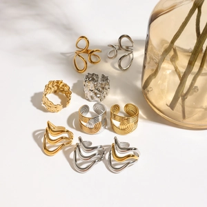 Detailed view of assorted 18k gold and silver textured minimalist stainless steel rings