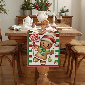 Christmas gingerbread man table runner with festive red and green stripes on a wooden table