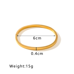 Polished gold stainless steel bangle detail with dimensions 6cm diameter and 0.4cm width