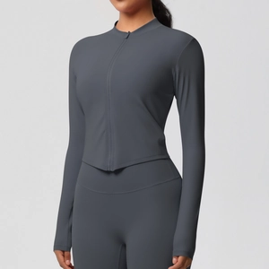 Détail de la veste de sport grise zippée et du legging de yoga au fini mat premium
