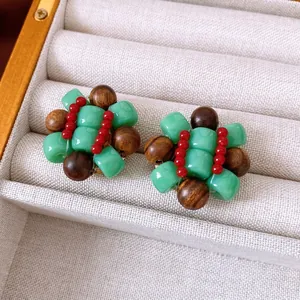 Ethnic style round resin beaded earrings with green and wood beads in a velvet jewelry box