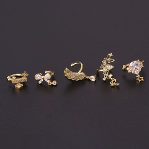 Elegant gold bow and feather ear bone clips with sparkling zircons on a dark backdrop