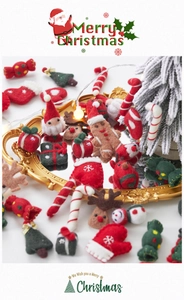 Macro detail of handmade wool felt Christmas ornaments including Santa, elk and gingerbread man