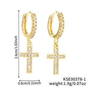 Detail of gold cross earrings with zircon pavé showing exact 2.6cm dimensions and weight