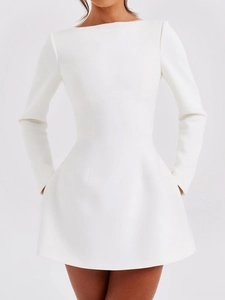Detailed view of white long-sleeve mini dress featuring practical side pockets and A-line hem