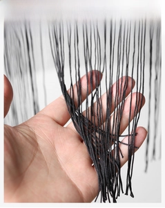 Detail of the black tassel fringe and woven texture on a pleated Halloween witch hat
