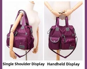 Detailed view of dark purple nylon shoulder bag with multiple front zipper pockets
