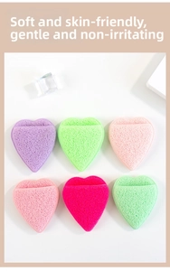Macro detail of heart-shaped facial sponges with honeycomb texture in various colors
