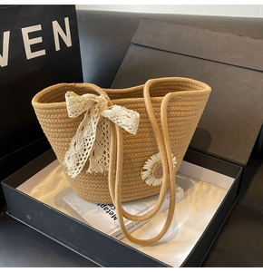 Detail of hand-woven tote bag with lace bow and daisy decor in a premium gift box