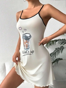 Detail of cream-white slip nightdress with black trim and coffee print pattern