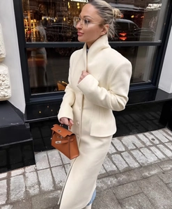 Detail of waist-slimming long wool coat featuring lapel collar and matching buttons