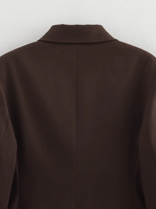 Close-up of dark brown blazer back showing fine woven texture and center seam detail