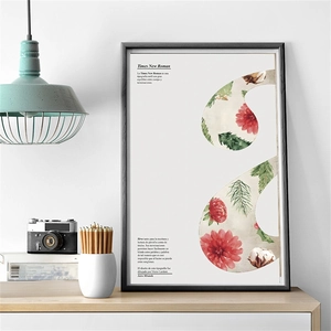 Artistic poster detail with a letter S design featuring red flowers and pine needles in a frame