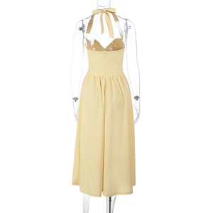 Detail of yellow halter neck dress back view with bow tie waist on a mannequin