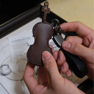 Brown leather violin keychain pendant with metal hook and strap for gift decoration