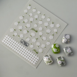 5D embossed camellia nail stickers with white flowers and green leaves on nails
