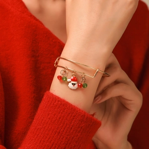 Close-up of adjustable Christmas bracelet with Santa charm and red green beads on wrist