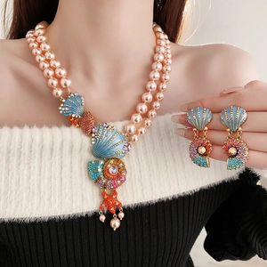 Detail of vintage necklace and earrings with pink pearls, blue seashells and starfish