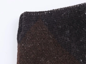 Detailed macro view of high-quality dark brown and black diamond knit fabric texture