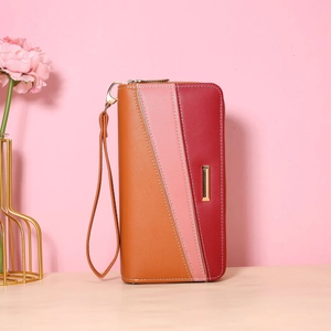 Detail of color block long wallet with wrist strap and elegant gold metal trim