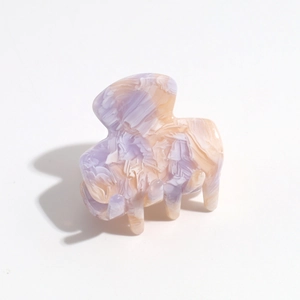 Macro shot of purple gradient marble hair claw clip with strong spring detail and rounded edges