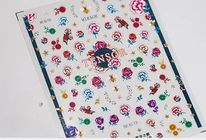 Macro detail of floral nail art stickers featuring colorful roses and bee patterns