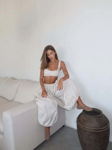 Detail view of cream two-piece lounge set with cropped vest and oversized lantern pants