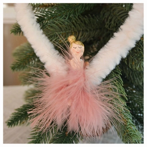 Pink feather fairy angel hanging ornament with plush wings on a Christmas tree