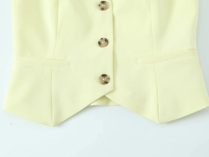Detail of light yellow fabric with tortoise shell buttons on a halter wide leg set