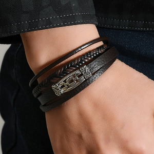 Close-up of vintage multi-layer braided leather bracelet with geometric alloy magnetic clasp