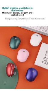 Electric head and scalp massager in five vibrant colors displayed on a modern orange desk