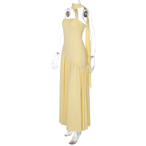 Detail of elegant yellow strapless dress with asymmetric draped hem and soft fabric texture