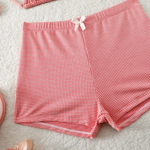 Close-up of red and white gingham bikini bottoms with a small white bow detail