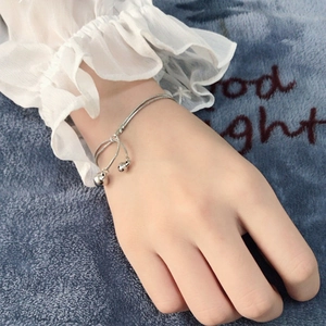 Close-up of silver titanium steel bracelet with double bells on blue plush fabric