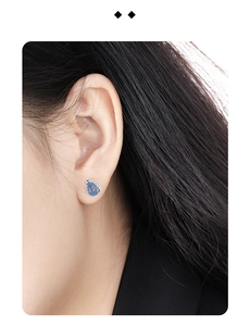 Detailed close-up of S925 sterling silver water drop earring with blue crystal on ear