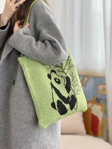 Cute panda knitted shoulder bag in vibrant grass green with artistic bamboo design