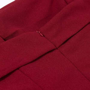 Close-up of the elegant red chiffon dress showing a hidden zipper and fine fabric texture