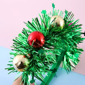 Christmas headband with festive green tinsel, red and gold ornaments, and star sequins