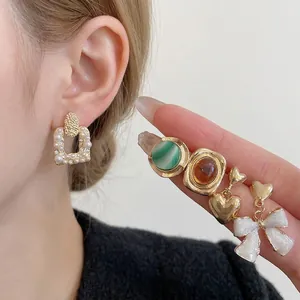 French vintage pearl and flower earring set with gold accents for stylish women